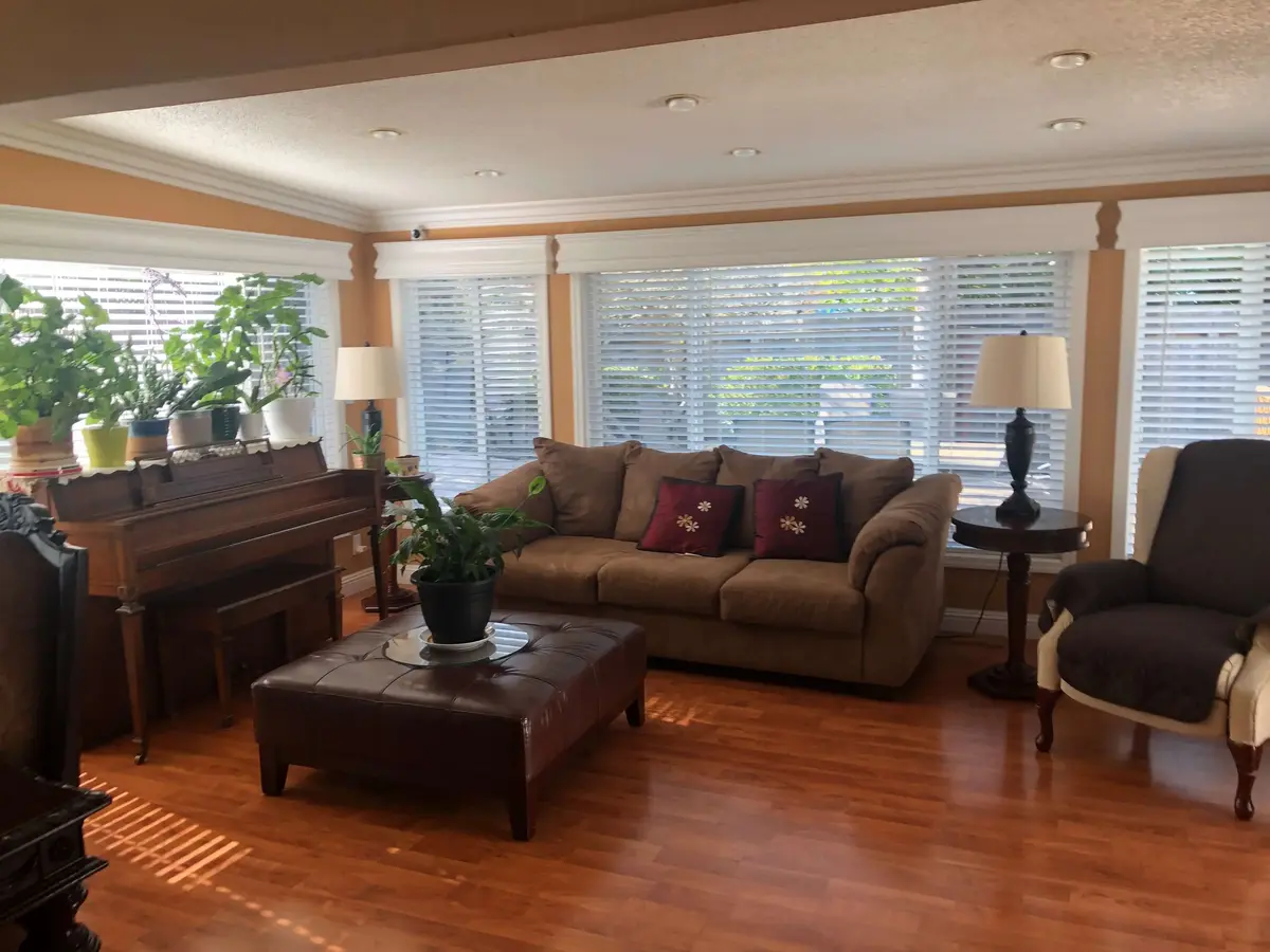 Modern living room with red chair and city view